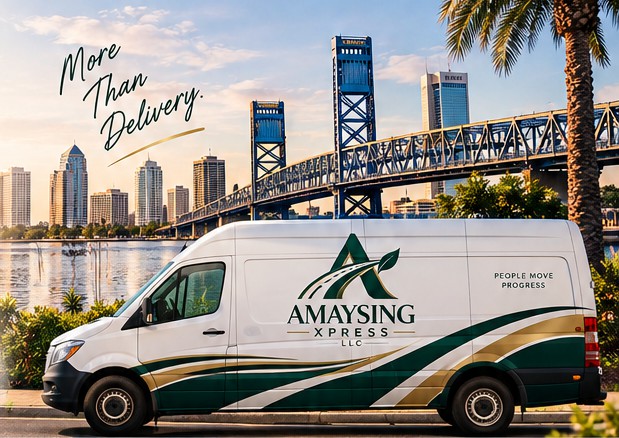 Amaysing Xpress cargo van parked along the St. Johns River with the Jacksonville skyline and Main Street Bridge behind it